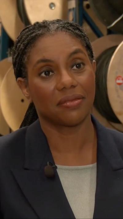 Kemi Badenoch wearing navy blazer and grey top