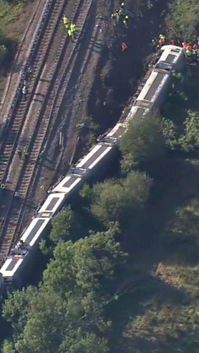 Derailed train seen on tracks from aerial view