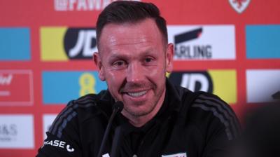 Craig Bellamy smiles as he speaks to the media