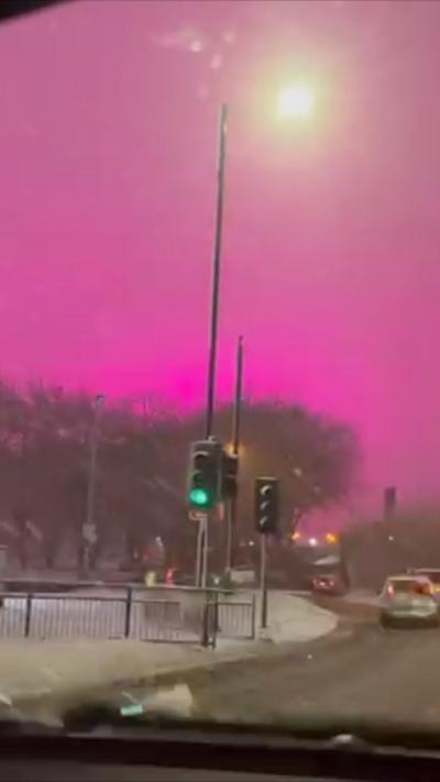 A pink sky in Birmingham in a snow covered city