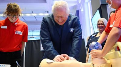 King Charles performs CPR on a mannequin as part of a life-saving demonstration