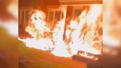 Large flames engulfing the front of a house in Glasgow.