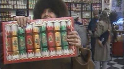 A woman holds a box of Christmas crackers