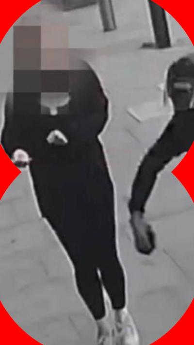 A motorcyclist grabbing a woman's phone on a London street