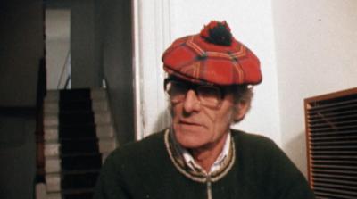 A man in a tartan hat on the building site