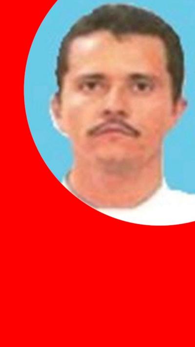 El Mencho has short dark hair, a moustache and is wearing a white t-shirt.