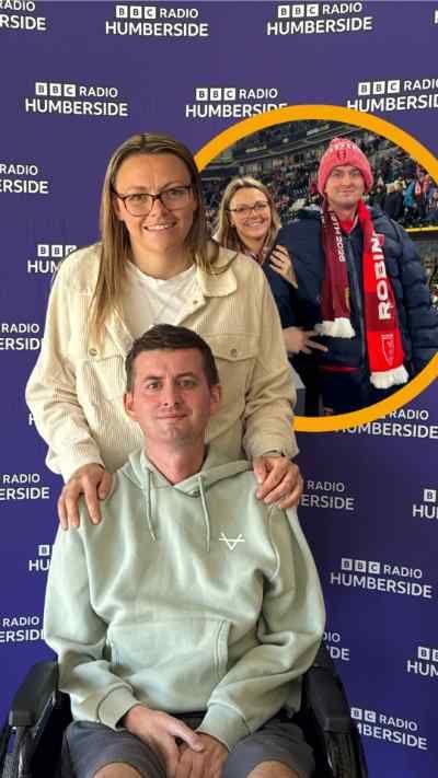 Man in wheelchair in front of his wife