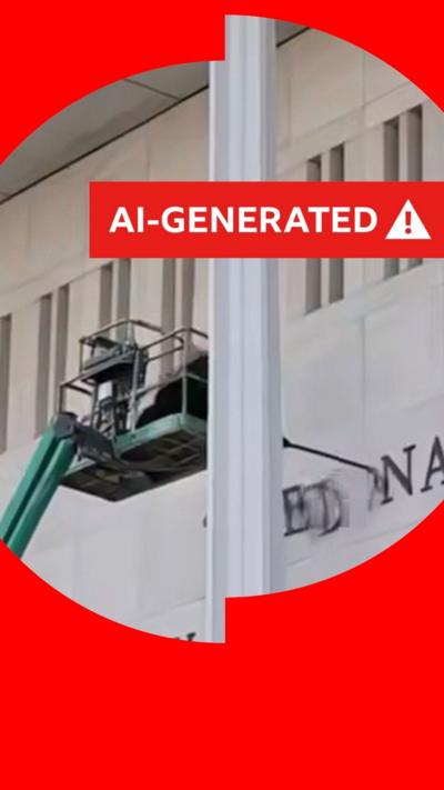 An AI-generated image of a green cherry-picker appearing to pull letters off the front of the Kennedy Center. A banner superimposed on the picture alerts viewers that it is AI-generated.