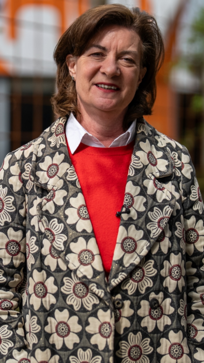 Eluned Morgan in a flowery blazer and bright red jumper
