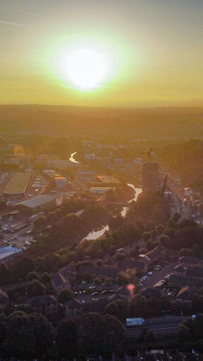An aerial photograph of Bristol at dawn with the sun on the horizon