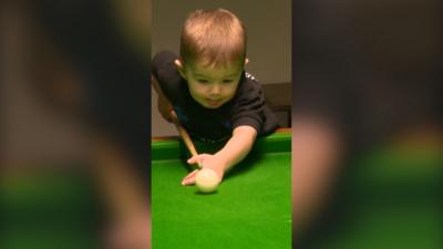 Child playing snooker