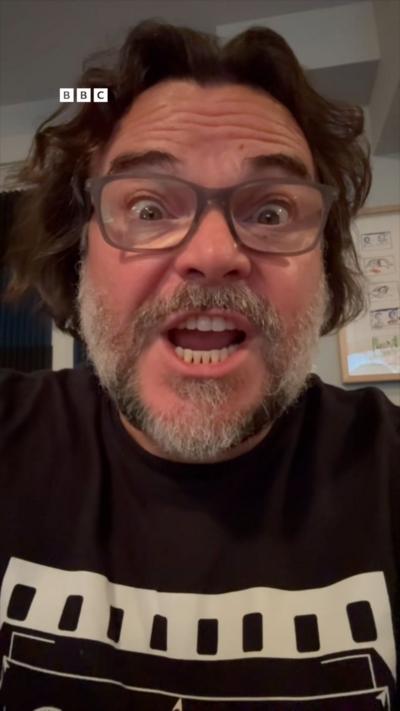 A selfie of Jack Black wearing light grey glasses.