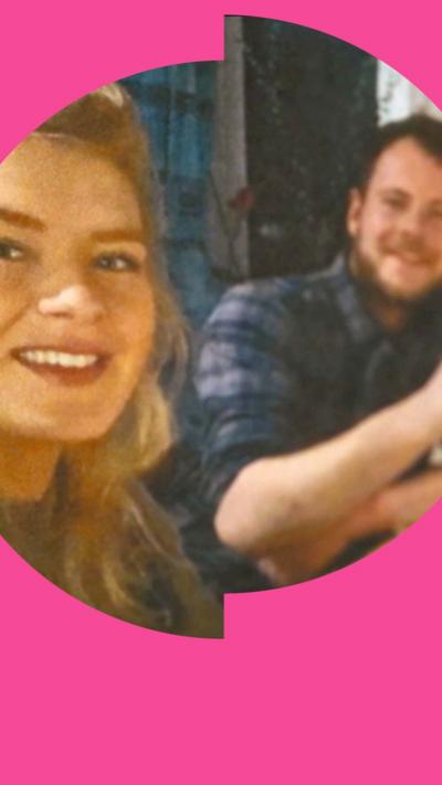 A woman and a man, both smiling, look into the camera. She has long blonde hair, he has short brown hair and wears a blue checked shirt 