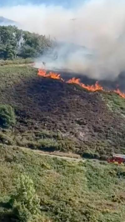 Flames and smoke on the side of a mountain
