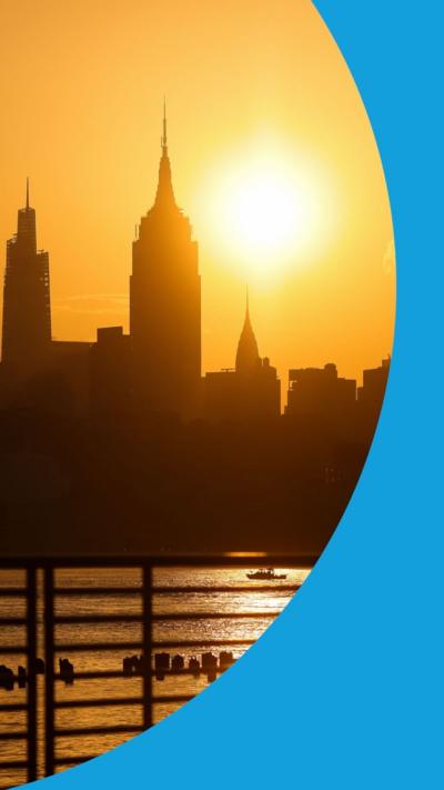 The New York City skyline silhouetted at sunrise.