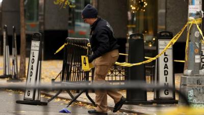 A police officer examines a shooting site in New York