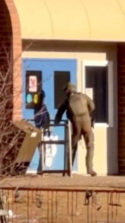 Armed officer entering school