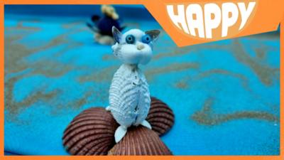 A cat made from sea shells and the Happy logo