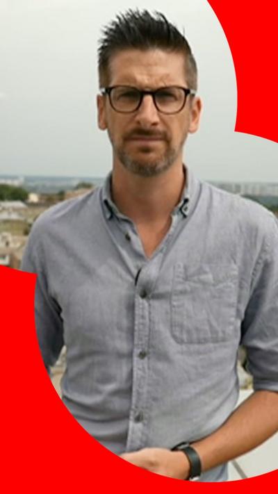BBC correspondent Dan Johson wearing blue shirt 
