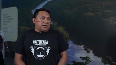 Brazilian indigenous leader stands during interview with BBC at COP30