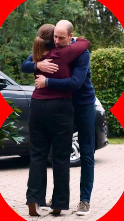 Prince William hugging a woman in a red jumper on her driveway