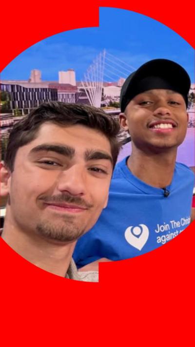 Selfie of Kush (left) has with short dark hair and Jo (right) who is wearing a cap and a blue t-shirt.