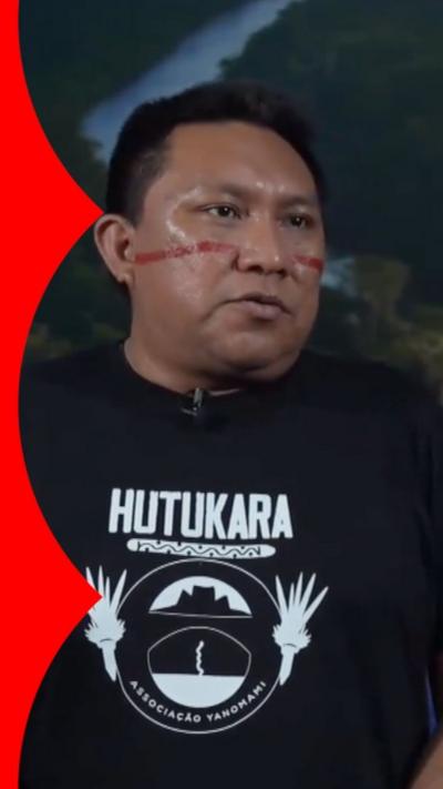 Brazilian indigenous leader Dario Kopenawa wears red face paint and a black tshirt during interview with BBC at COP30