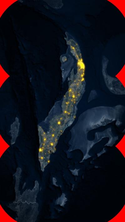 A satellite image of Cuba, showing areas of the island where lights are shining at night.