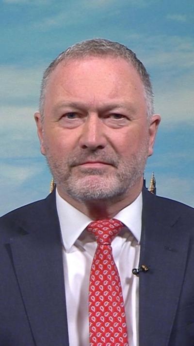 Steve Reed in a red tie