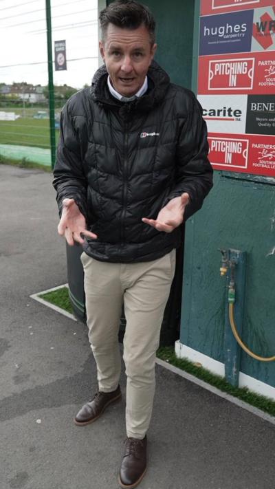 Andy stood in front of a football pitch