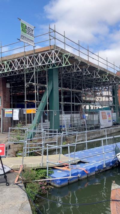 A boatyard with alot of scaffolding around it. 