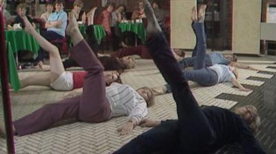 A group of women doing tummy flattening exercises