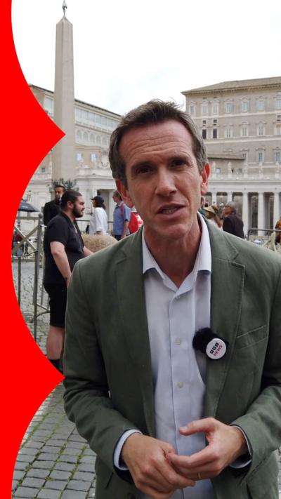 Mark Lowen stands in St Peter's Square wearing a suit jacket