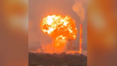 An orange fireball surges into the sky above a Russian oil facility.