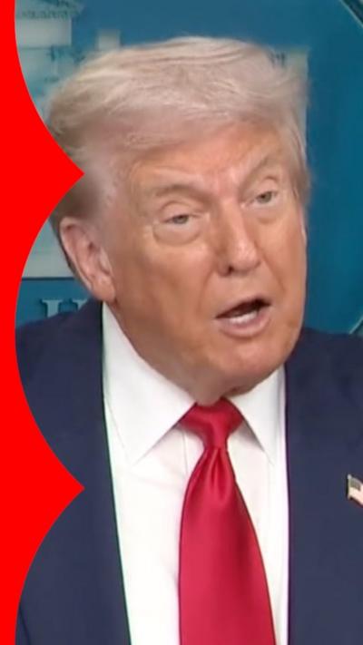 Donald Trump in a navy blue suit and red tie