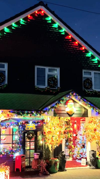Exterior of house decorated with lots of Chjristmas lights and decorations