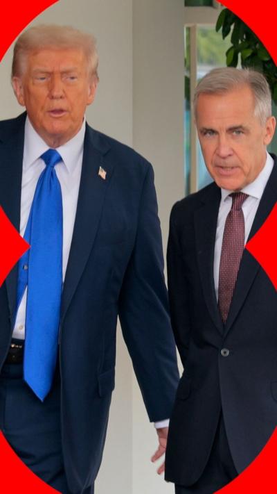Two men stand between the US and Canadian flags.