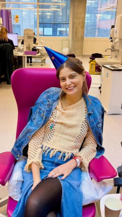 Flo wears a party hat while receiving chemotherapy treatments.
