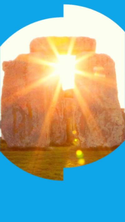 Sun shines through a stone arch at Stonehenge