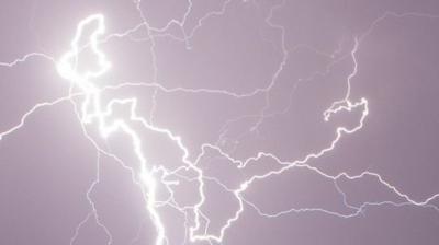 Bright lightning strike cuts through dark skies