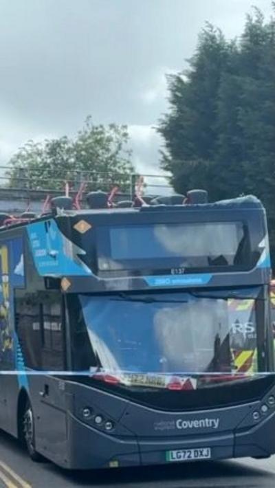 grey bus with no roof