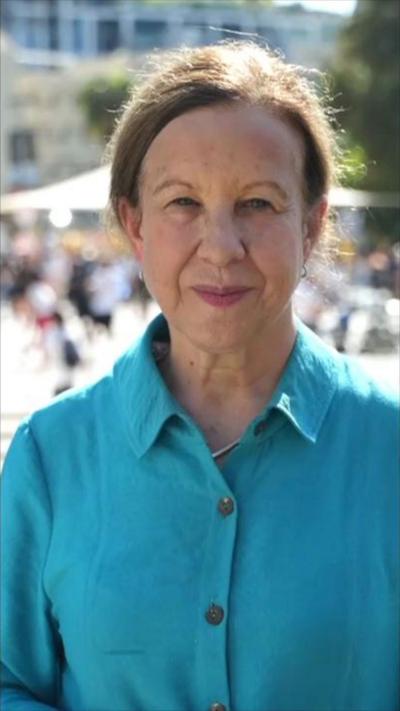Lyse Doucet wearing a blue shirt 