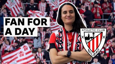 Athletic Club fan with club's badge stands with her arms crossed