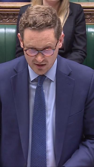 Darren Jones wears a blue suit