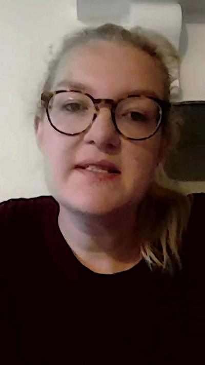 Emily Barley. She has long blond hair tied back and is wearing glasses. 
