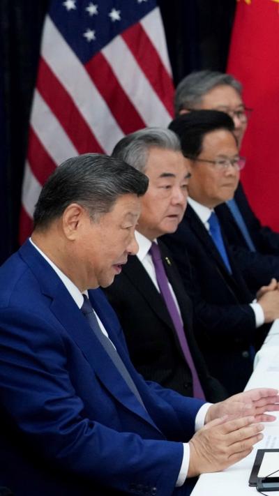 Xi Jinping and Chinese officials sitting a meeting table