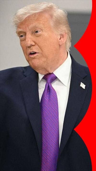 Donald Trump in a vertical shot, speaking to someone off to his right with a purple tie and an American pin on his lapel