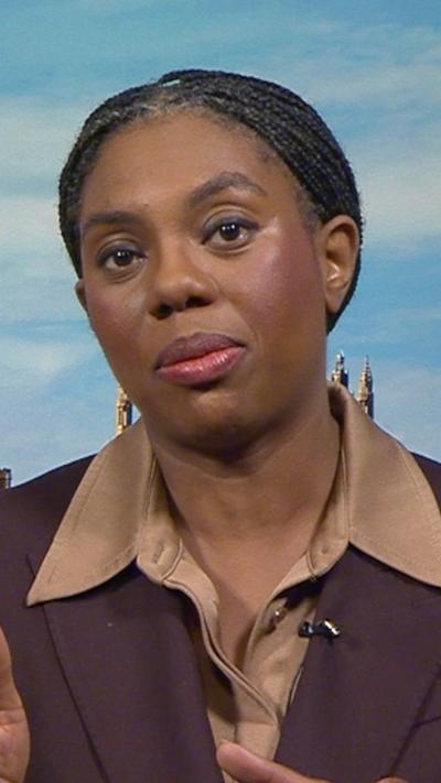 Kemi Badenoch wearing a brown suit during a TV interview