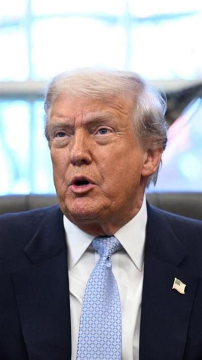 US President Donald Trump wearing light blue tie and navy blazer 