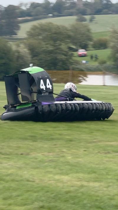 A hovercraft races on grass.